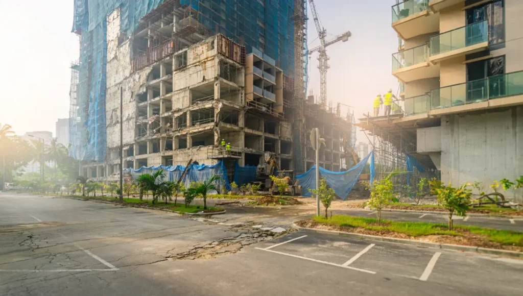 Ultra-realistic architectural photography of tropical mall adaptive reuse into residential housing, featuring light well perforations in deep floor plates, vertical tropical gardens on raw concrete, brushed brass smart facades, weathered oak stoops, modular pods, and hyper-mixed-use interiors for carbon-efficient, resilient urban development in humid environments like Da Nang.